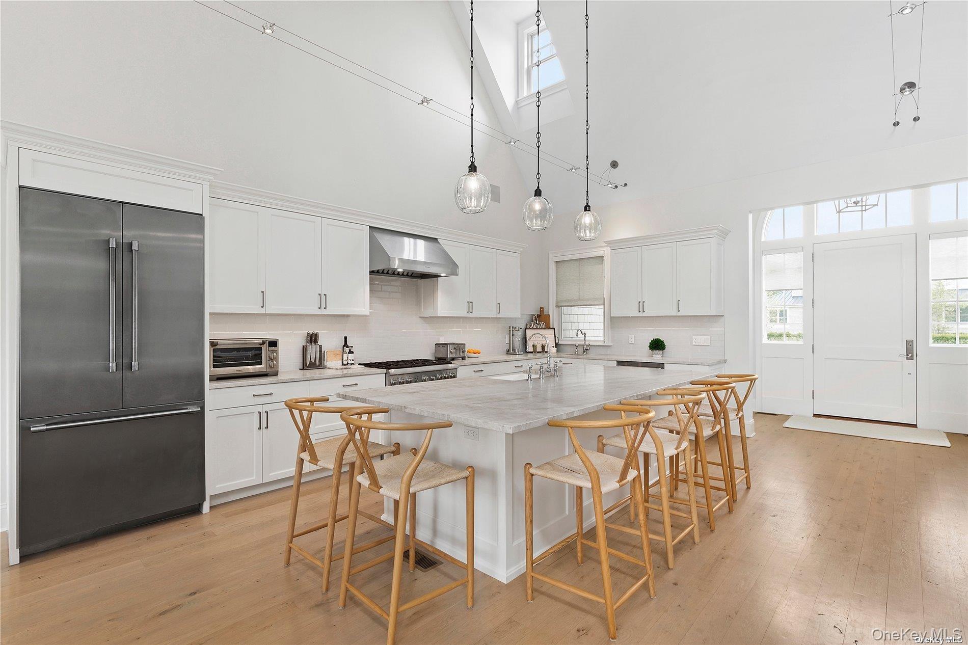 2 Emmas Path Remsenburg, NY 11960 - Photo 3 of 23 a kitchen with stainless steel appliances granite countertop a sink a stove a refrigerator and island with wooden floor