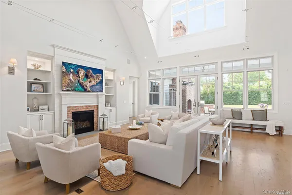 a living room with furniture a fireplace and a large window