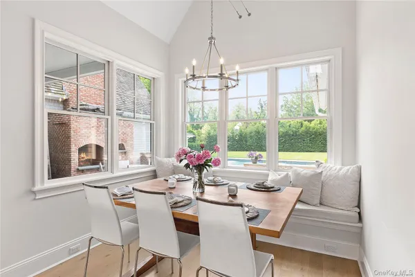 a view of a dining room with furniture large windows and wooden floor