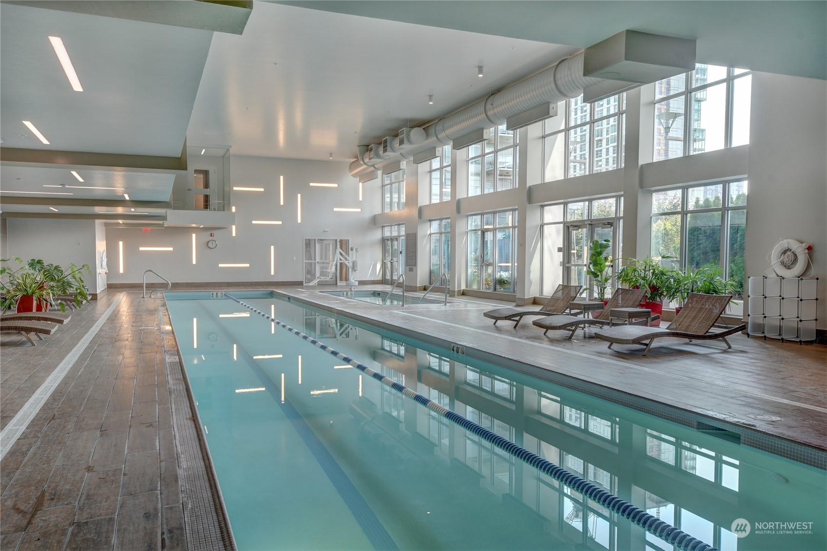 583 Battery Street, Unit 1601N Seattle, WA 98121 - Photo 16 of 27 a large white kitchen with lots of counter top space and a potted plant