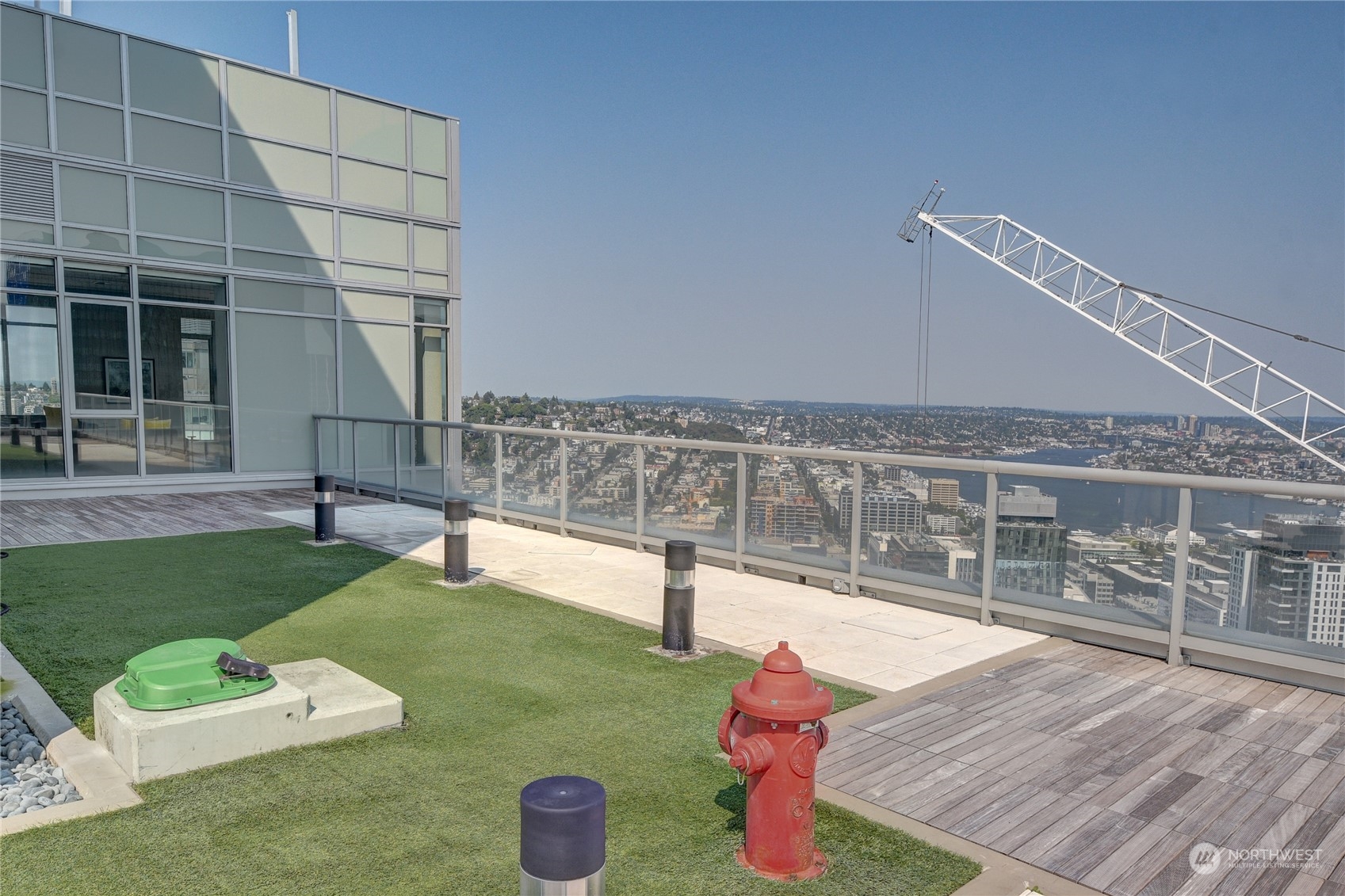 583 Battery Street, Unit 1601N Seattle, WA 98121 - Photo 23 of 27 a view of a chairs and table on the wooden deck