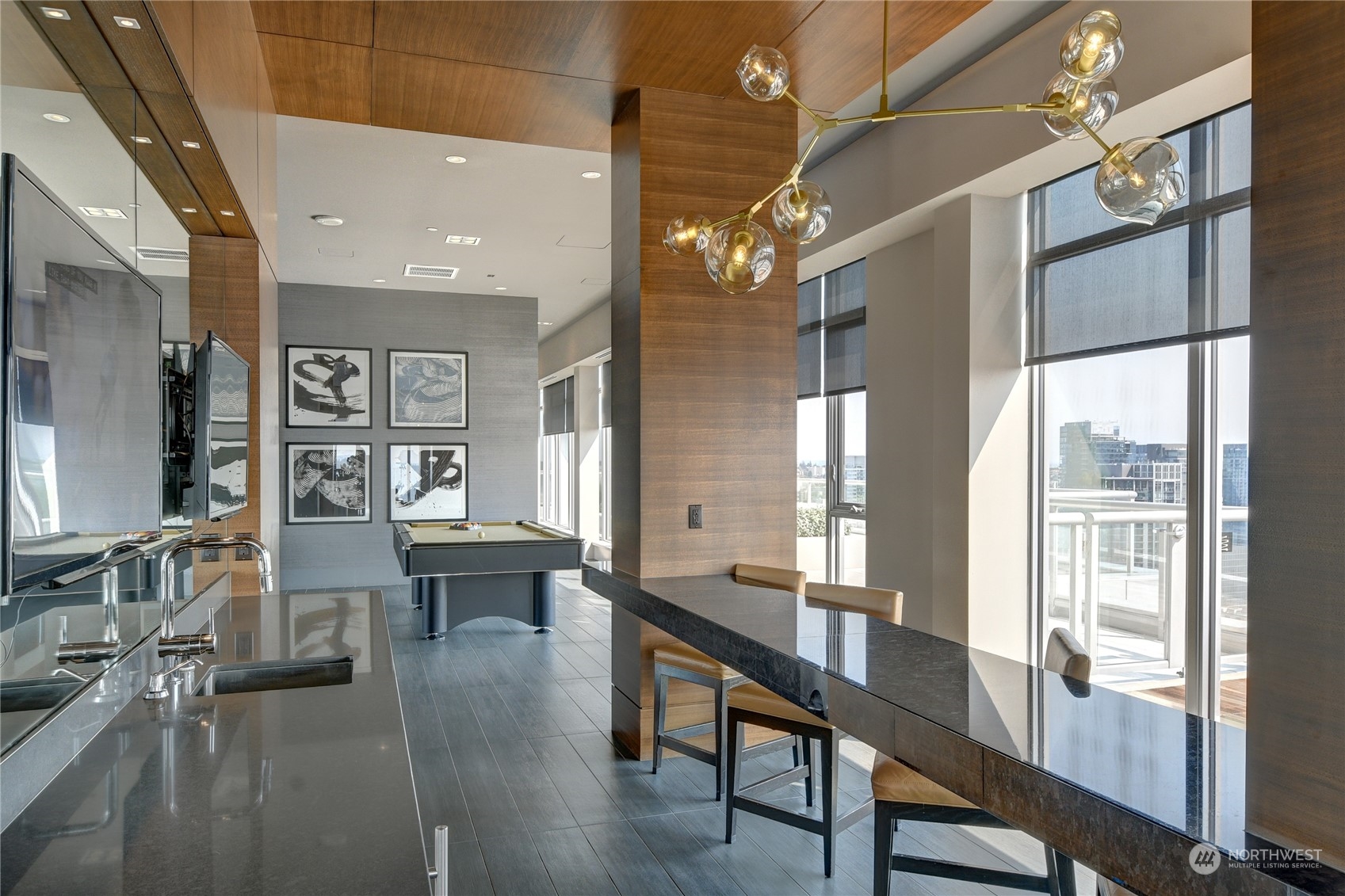 583 Battery Street, Unit 1601N Seattle, WA 98121 - Photo 25 of 27 a view of a dining room with furniture a chandelier and wooden floor