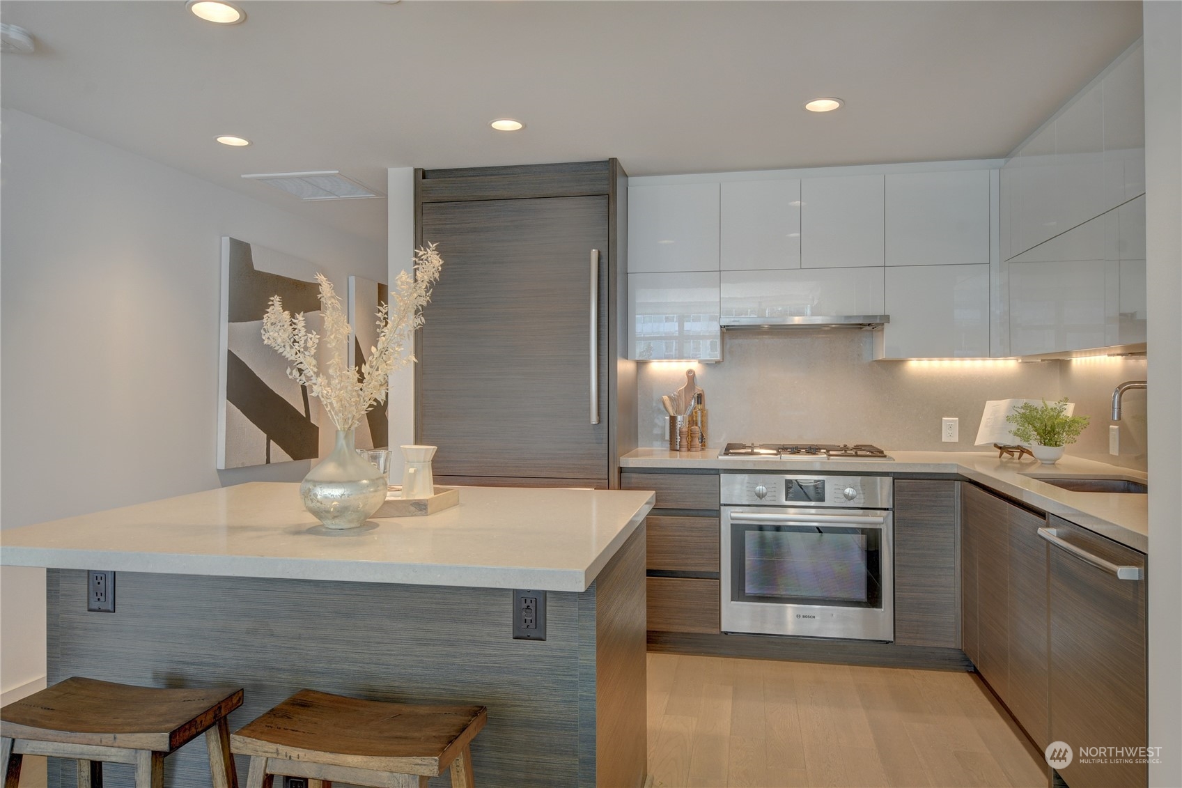 583 Battery Street, Unit 1601N Seattle, WA 98121 - Photo 6 of 27 a kitchen with stainless steel appliances granite countertop a stove and a sink