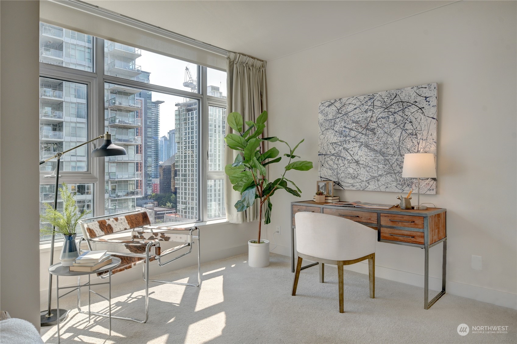 583 Battery Street, Unit 1601N Seattle, WA 98121 - Photo 9 of 27 a living room with furniture a table and a potted plant