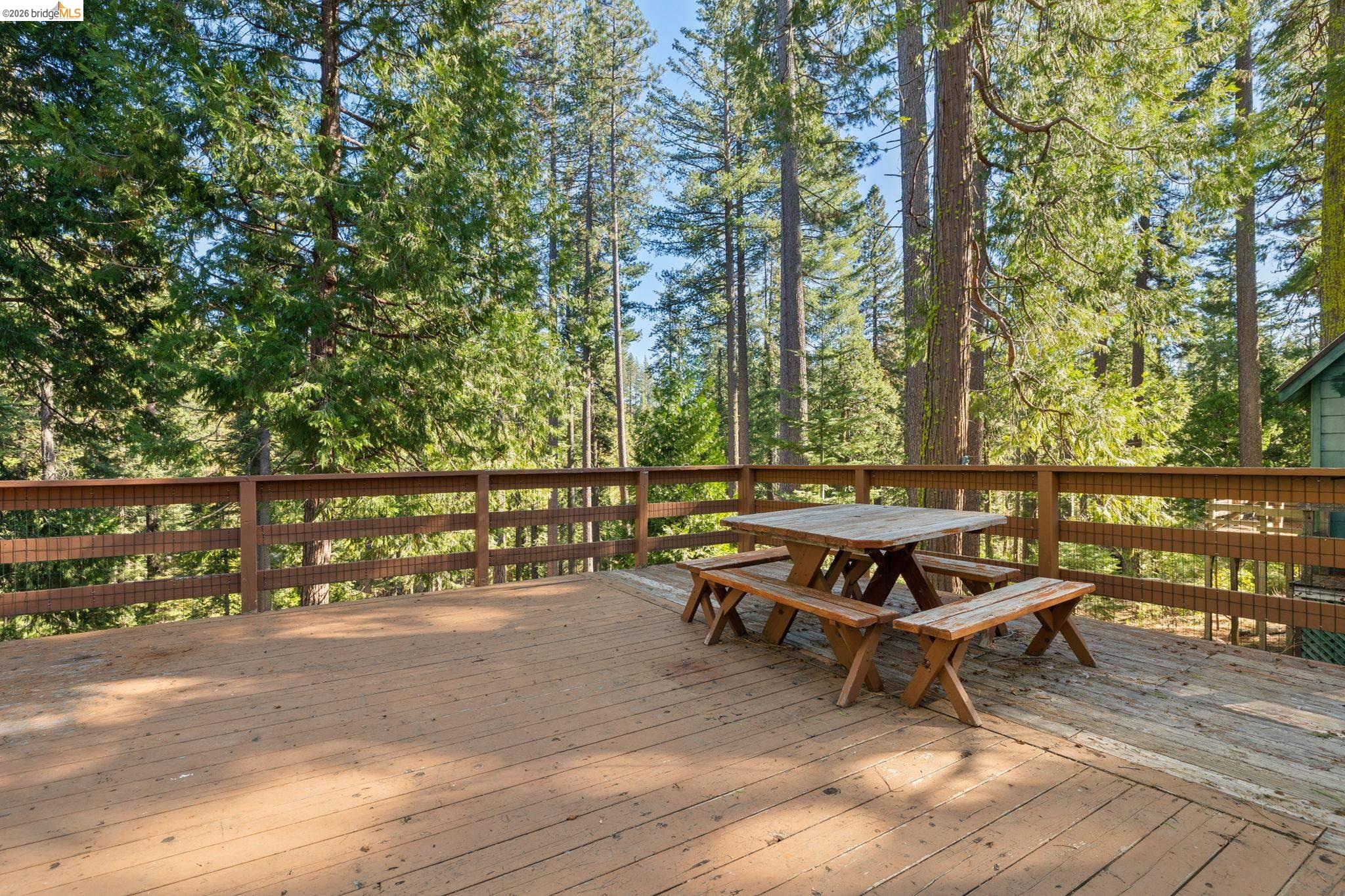 26175 Janice Way Long Barn, CA 95335 - Photo 21 of 23 Wooden deck featuring outdoor dining area and view of scattered trees