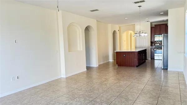 a view of kitchen with stainless steel appliances granite countertop a refrigerator and a sink