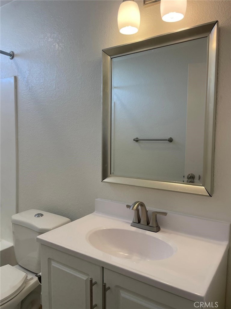 8135 Reseda Boulevard, Unit 9 Reseda, CA 91335 - Photo 5 of 8 a bathroom with a sink and a toilet