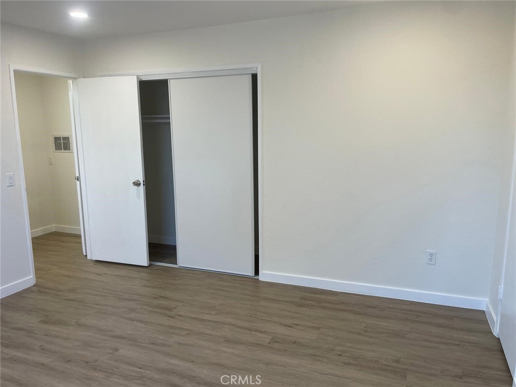 8135 Reseda Boulevard, Unit 9 Reseda, CA 91335 - Photo 7 of 8 a view of an empty room with wooden floor and closet