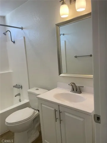 a bathroom with a sink toilet and mirror