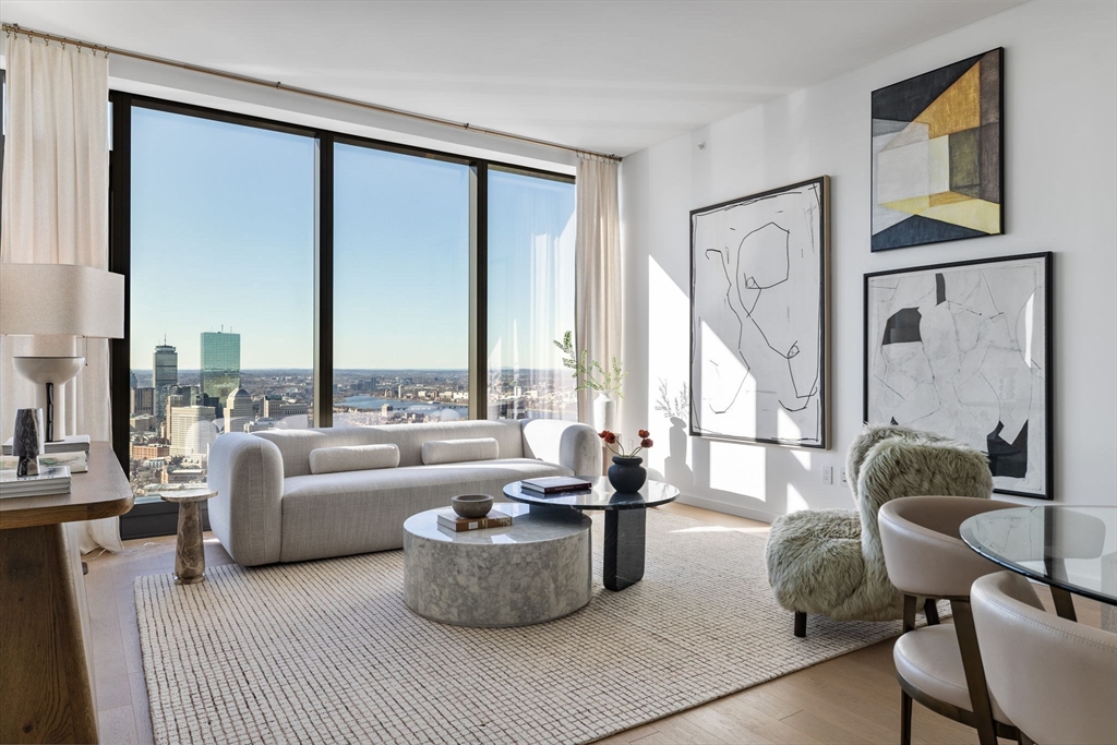 682 Atlantic Avenue, Unit 37D Boston, MA 02111 - Photo 1 of 42 a living room with furniture and large windows