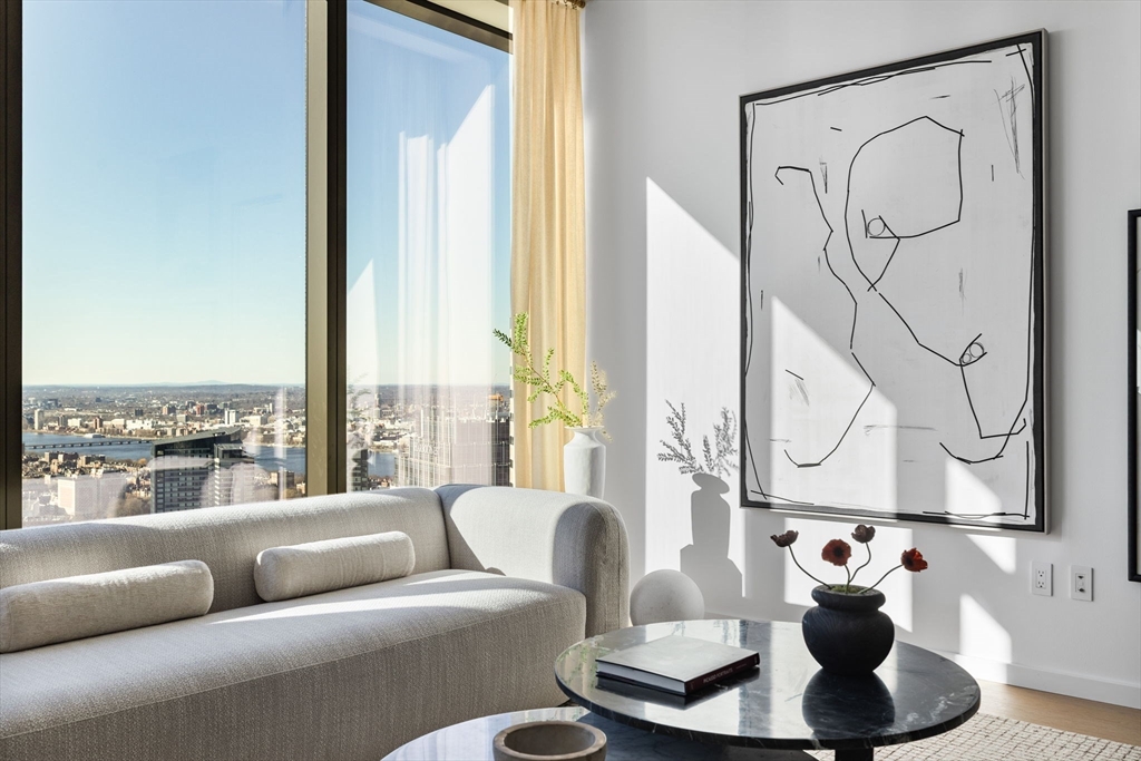 682 Atlantic Avenue, Unit 37D Boston, MA 02111 - Photo 2 of 42 a living room with furniture and a large window