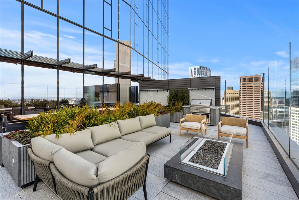 682 Atlantic Avenue, Unit 37D Boston, MA 02111 - Photo 30 of 42 a living room with furniture a rug and a floor to ceiling window
