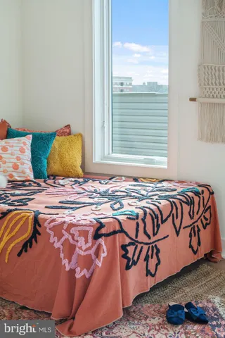 a bedroom with a bed a mirror and a window