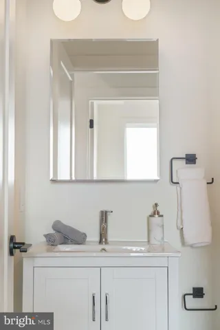 a view of a hallway with wooden floor and entryway