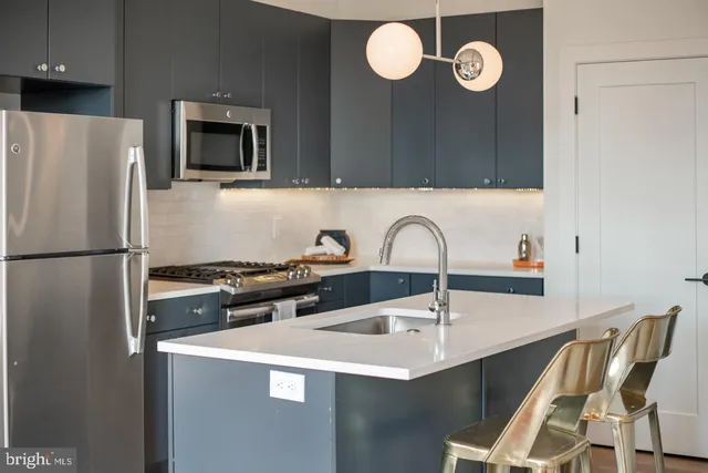 a kitchen with a sink cabinets and stainless steel appliances