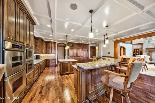 a kitchen with a table chairs stove and cabinets