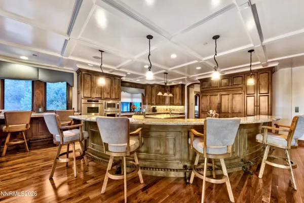 a dining area with glass top table and chairs