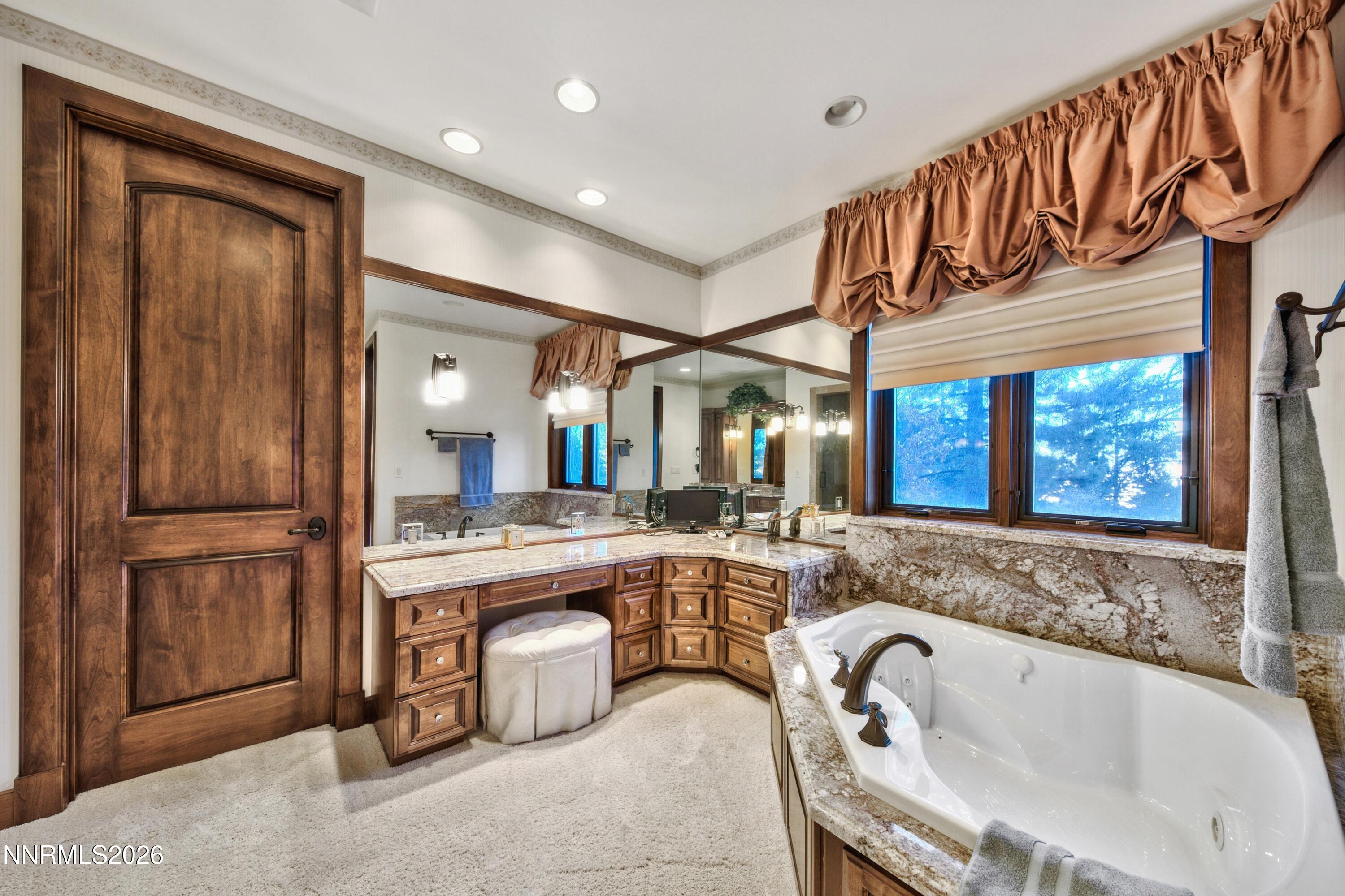 229 Five Creek Road Gardnerville, NV 89460 - Photo 22 of 50 a spacious bathroom with a granite countertop tub sink and mirror