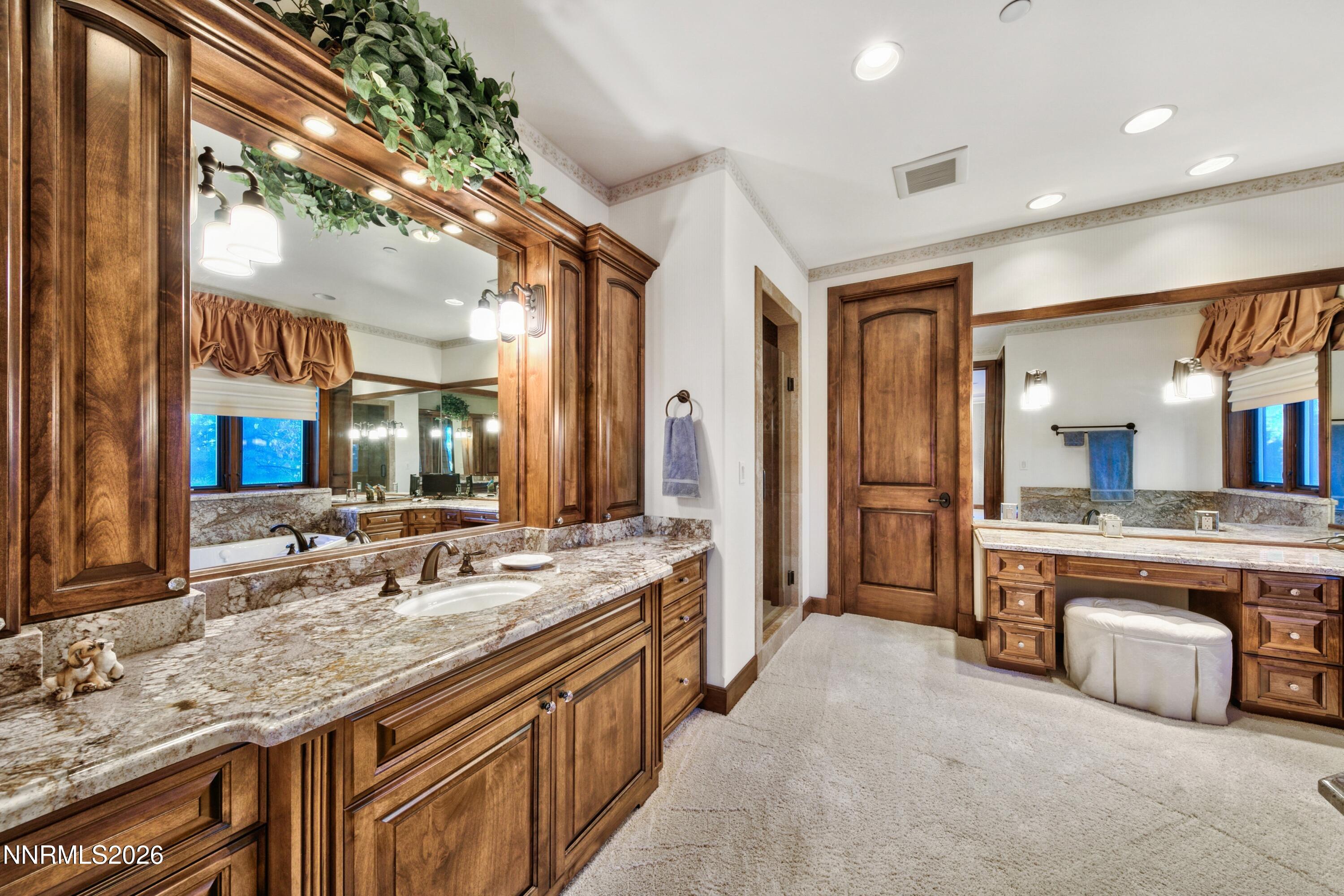 229 Five Creek Road Gardnerville, NV 89460 - Photo 23 of 50 a spacious bathroom with a granite countertop double vanity sink a mirror and a bathtub