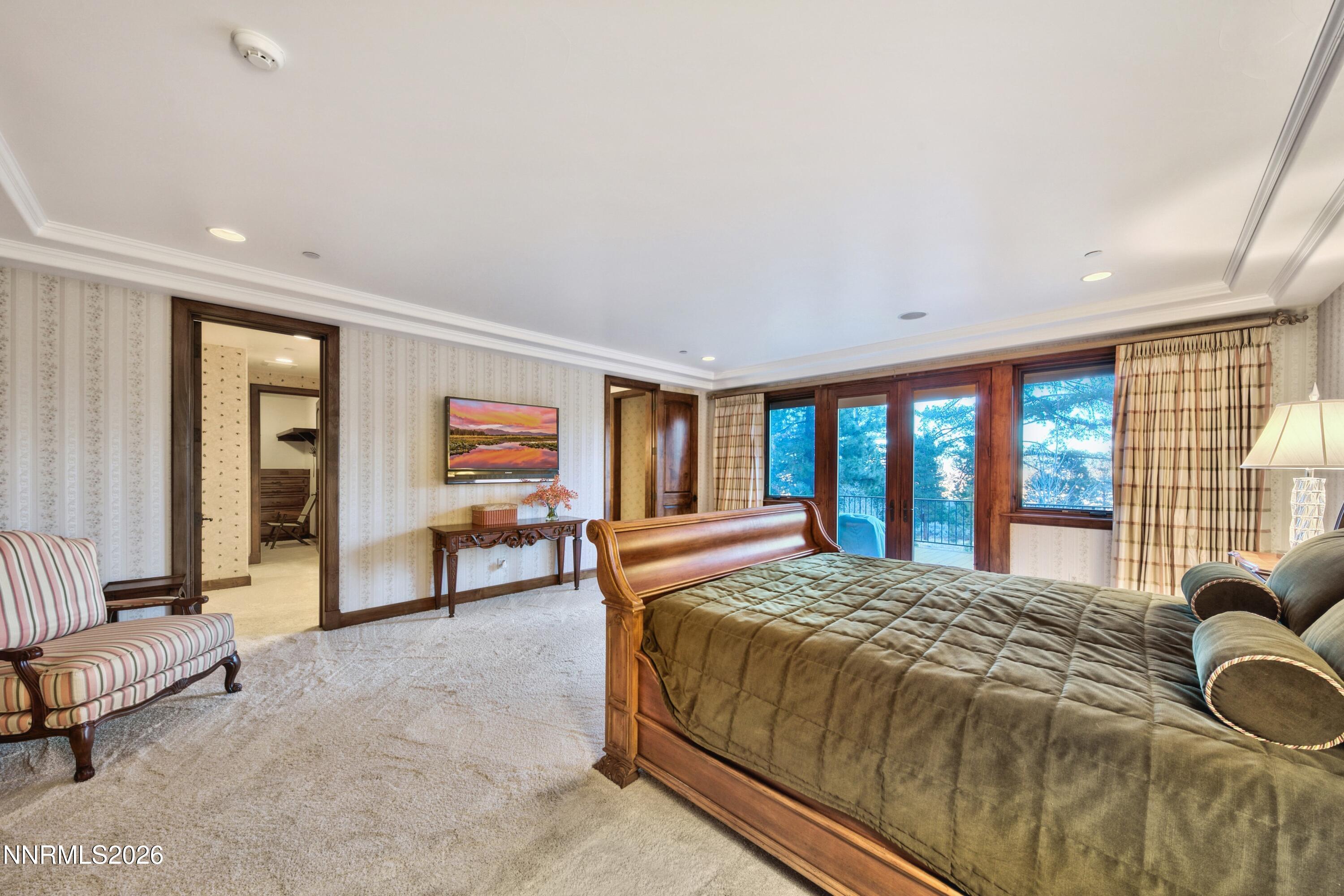 229 Five Creek Road Gardnerville, NV 89460 - Photo 24 of 50 a spacious bedroom with a bed and a couch