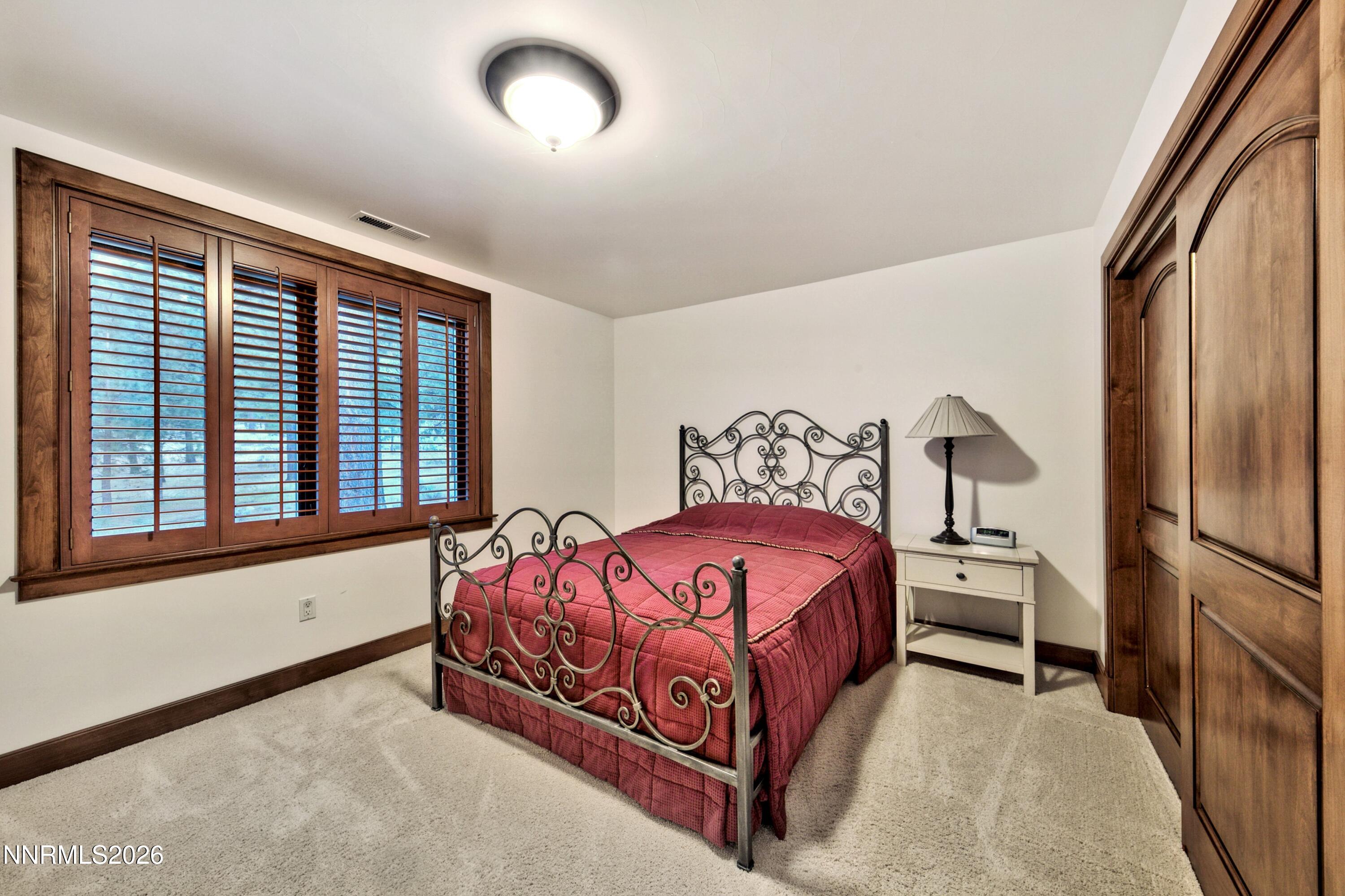229 Five Creek Road Gardnerville, NV 89460 - Photo 37 of 50 a bedroom with a bed next to a large window