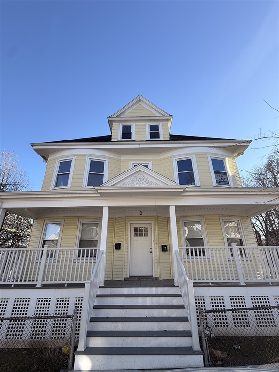 a view of a house with a wooden deck
