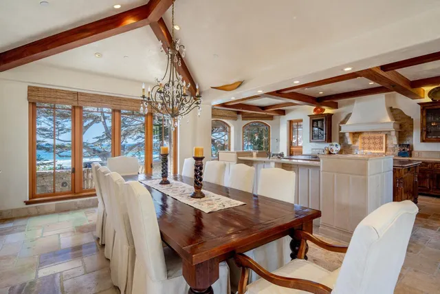 a dining room with furniture a chandelier and wooden floor
