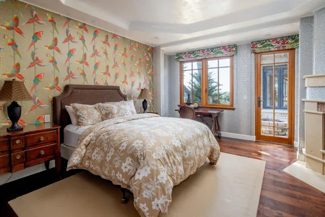 a bed sitting in a bedroom next to a window with a dresser