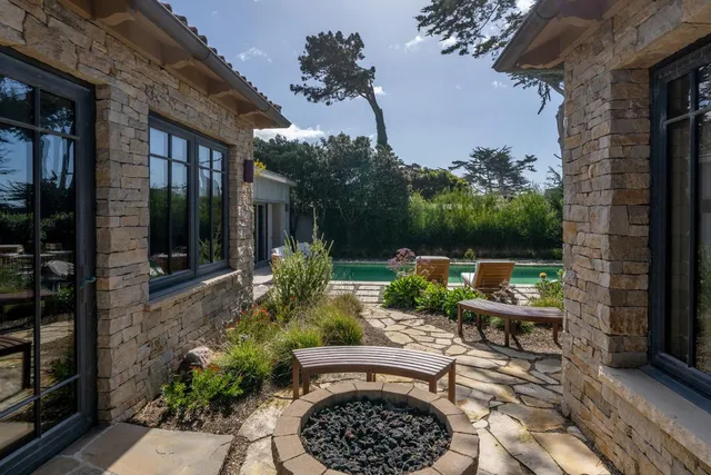 a view of a patio with table and chairs potted plants with wooden floor and fence