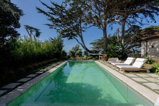 a view of a house with swimming pool and sitting area