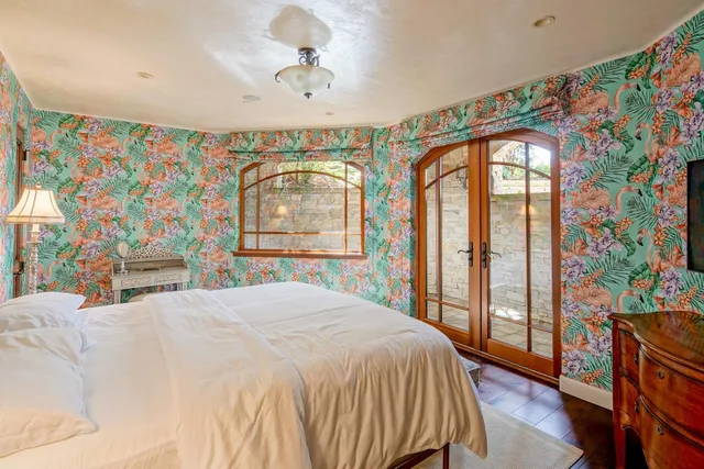 a bedroom with a large bed and a chandelier