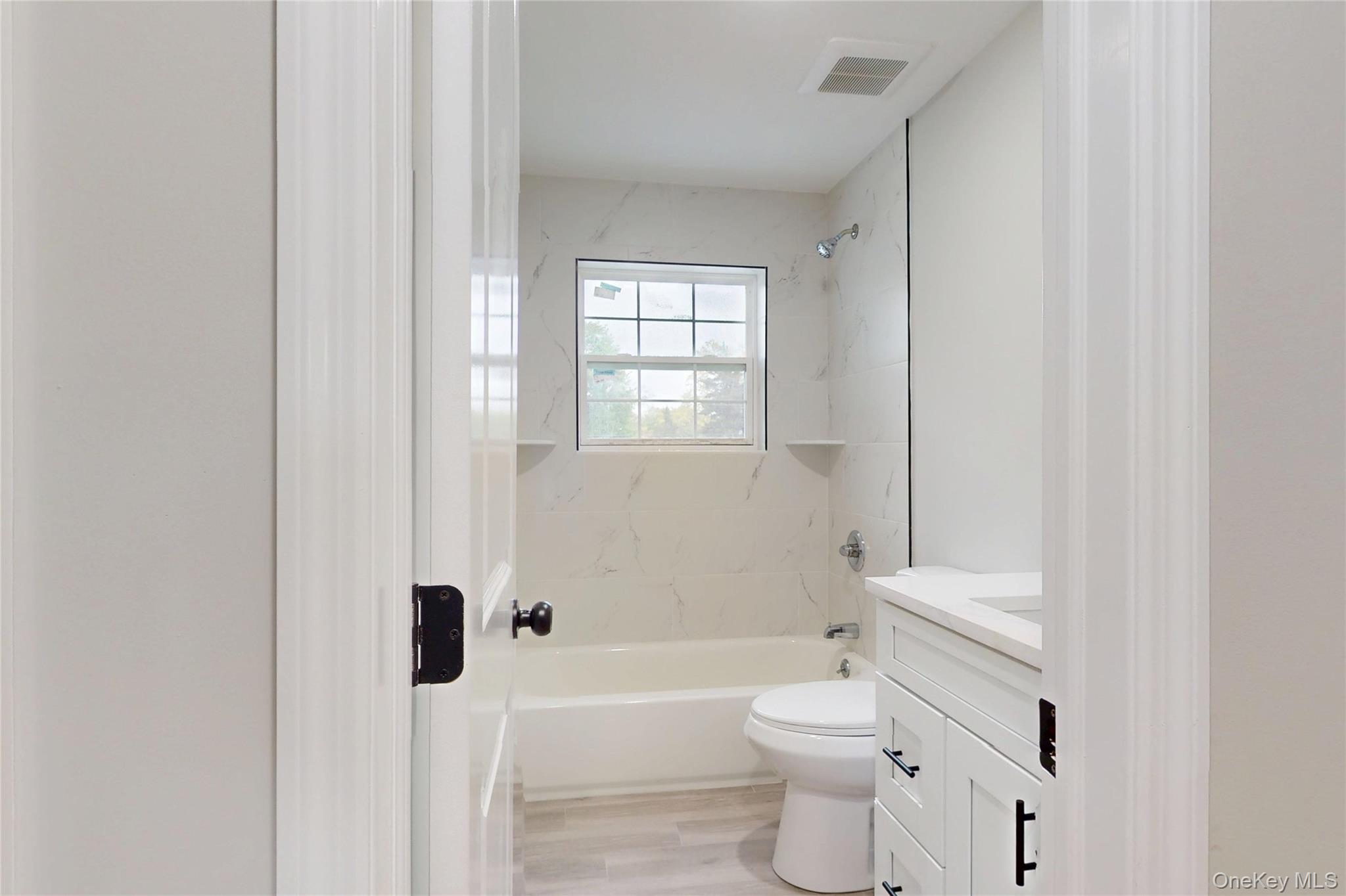 492 Blue Point Road Farmingville, NY 11738 - Photo 20 of 21 a bathroom with a toilet a sink and a bathtub