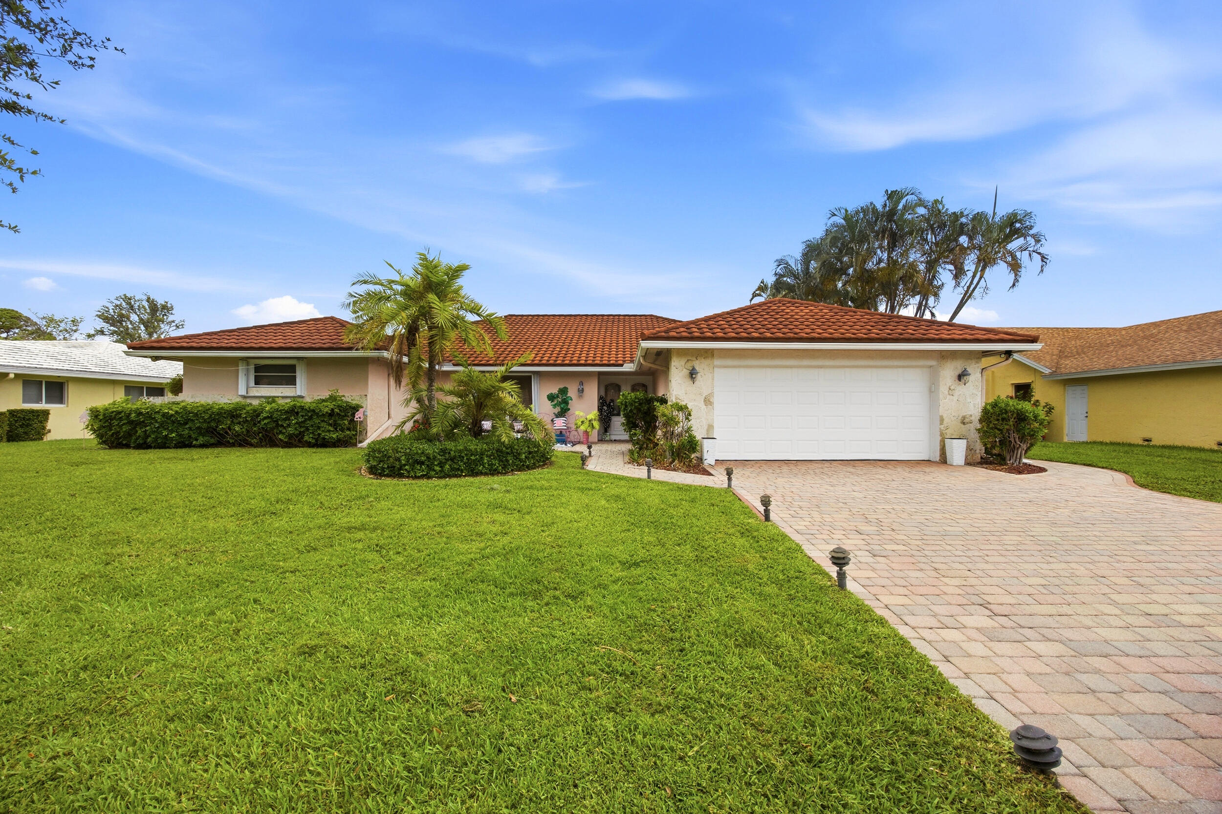 a front view of a house with a garden