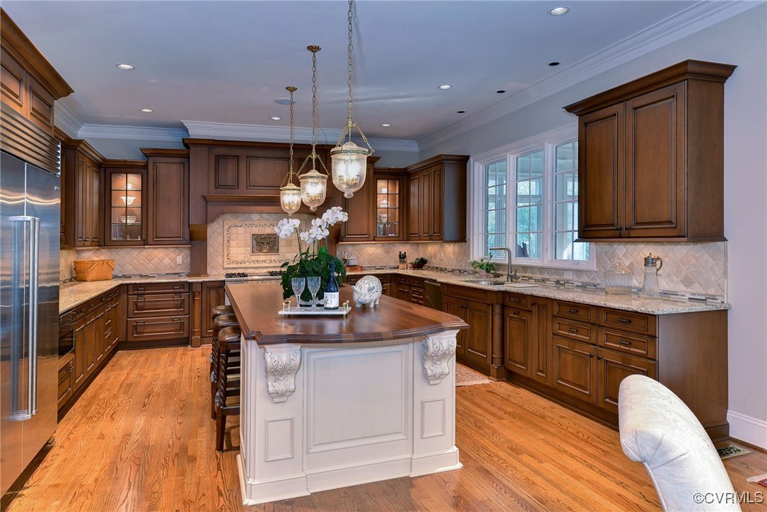 1220 Two Rivers Point Williamsburg, VA 23185 - Photo 14 of 50 a kitchen with kitchen island granite countertop a sink cabinets and wooden floor