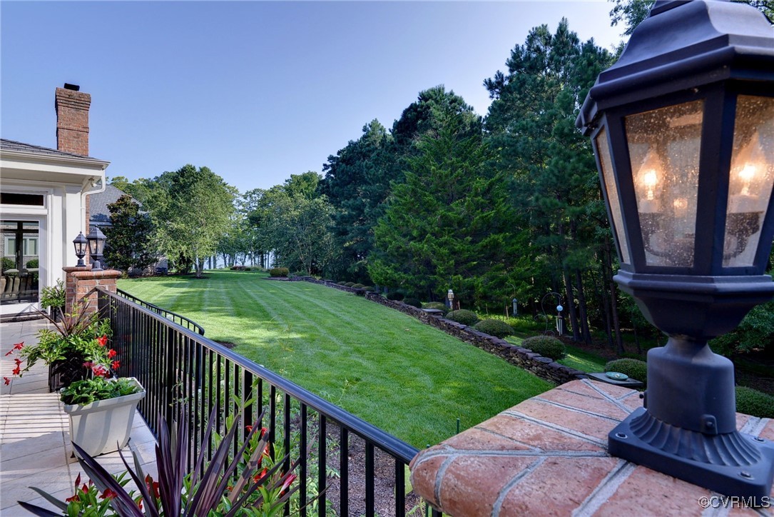 1220 Two Rivers Point Williamsburg, VA 23185 - Photo 47 of 50 a view of a fire pit in front of a brick house with a small yard