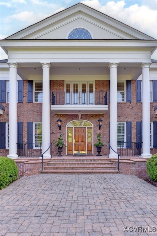 1220 Two Rivers Point Williamsburg, VA 23185 - Photo 5 of 50 a front view of a brick house with many windows
