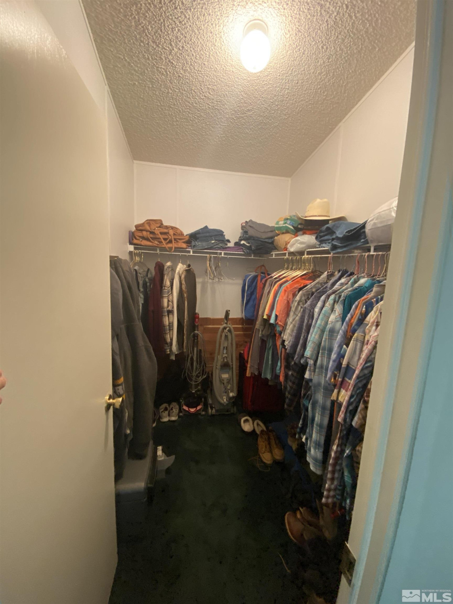 451 Manley Ranch Road Round Mountain, NV 89045 - Photo 15 of 40 a view of walk in closet with clothes and shoes