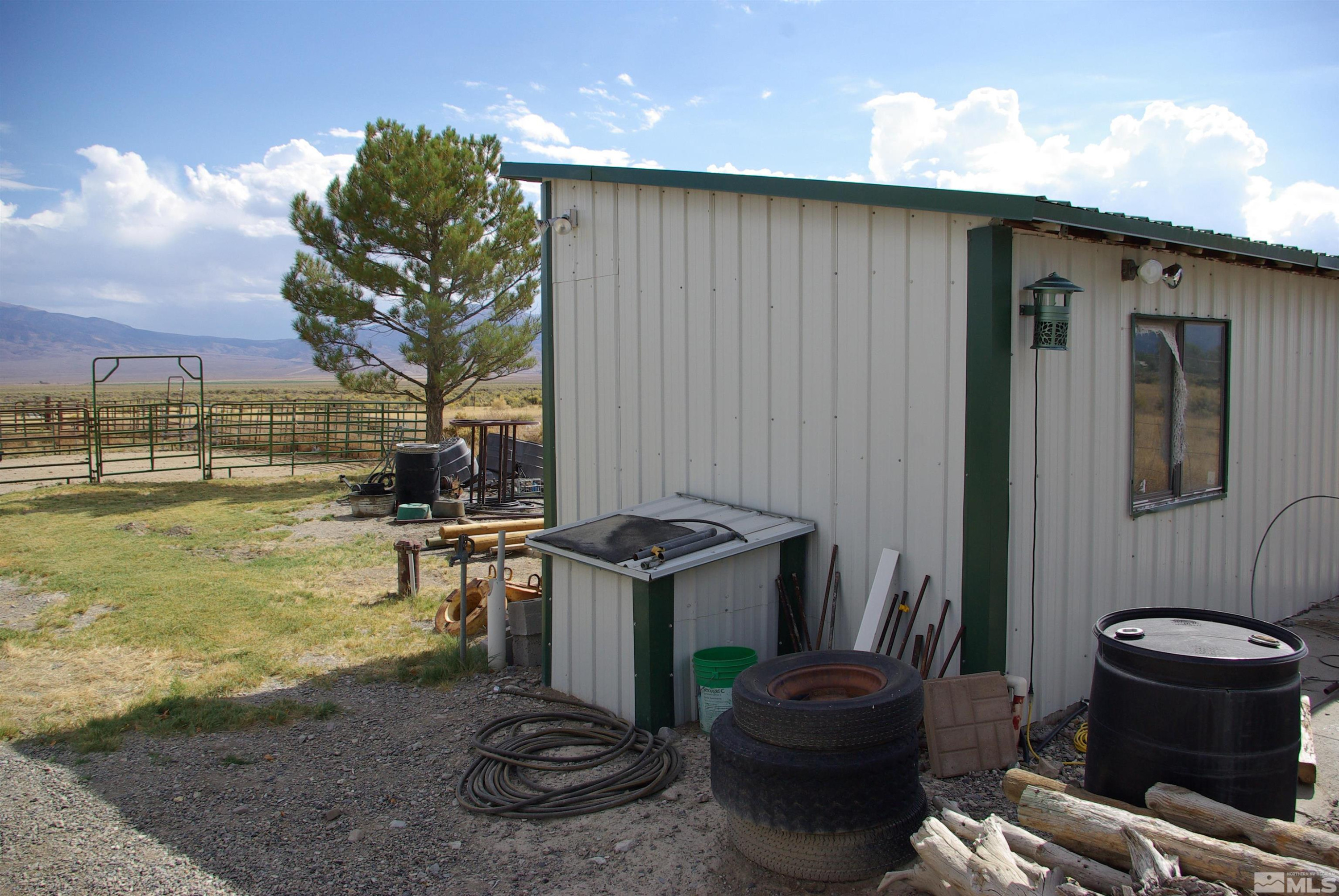 451 Manley Ranch Road Round Mountain, NV 89045 - Photo 36 of 40 a view of a porch with furniture and a yard