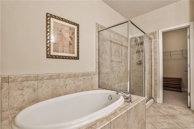 a bathroom with a bathtub and shower