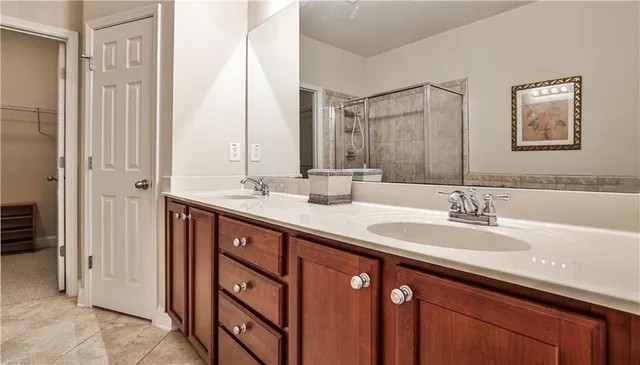 a bathroom with a double vanity sink and a mirror