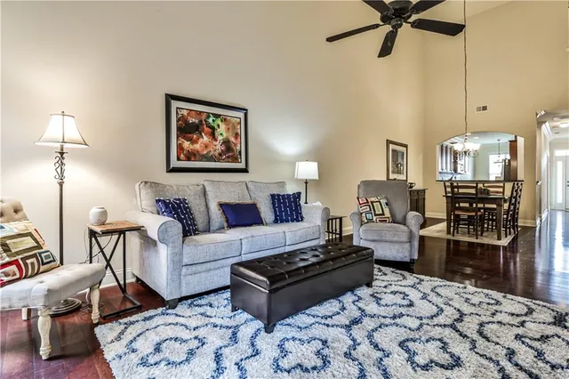 a living room with furniture a couch and a chandelier