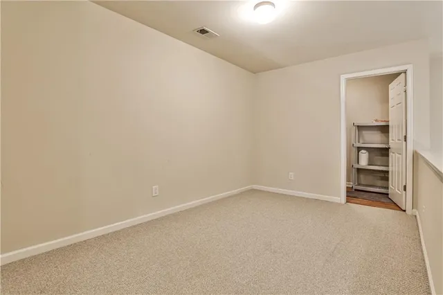 a view of an empty room with a closet
