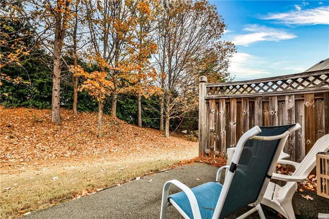 a backyard of a house with table and chairs