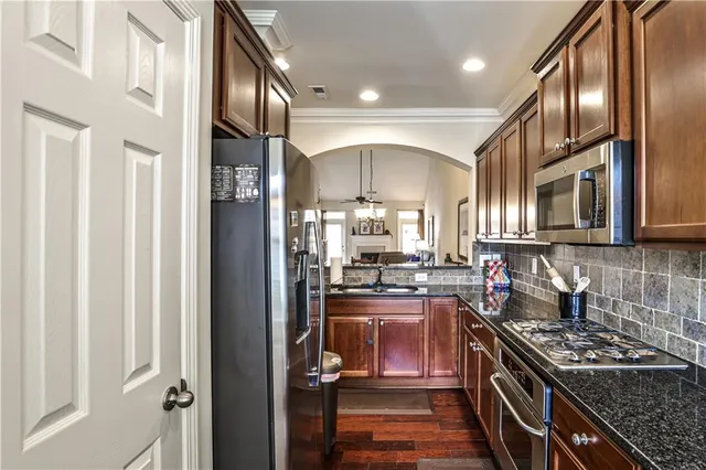 a kitchen with stainless steel appliances granite countertop a stove and a sink