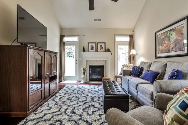 a living room with furniture a window and a fireplace