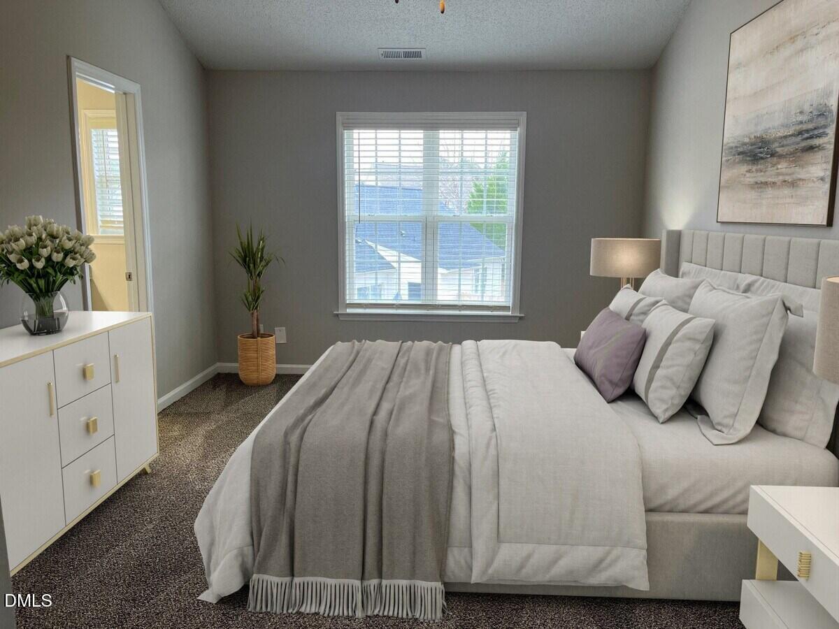 2101 Blackwolf Run Lane, Unit COLONIAL Raleigh, NC 27604 - Photo 10 of 30 a bedroom with a bed and a potted plant