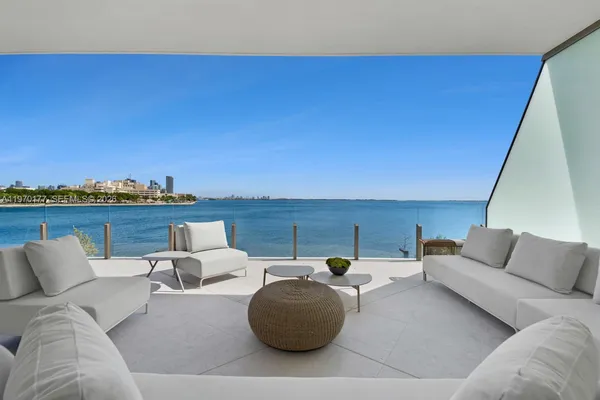 a living room with furniture and a floor to ceiling window