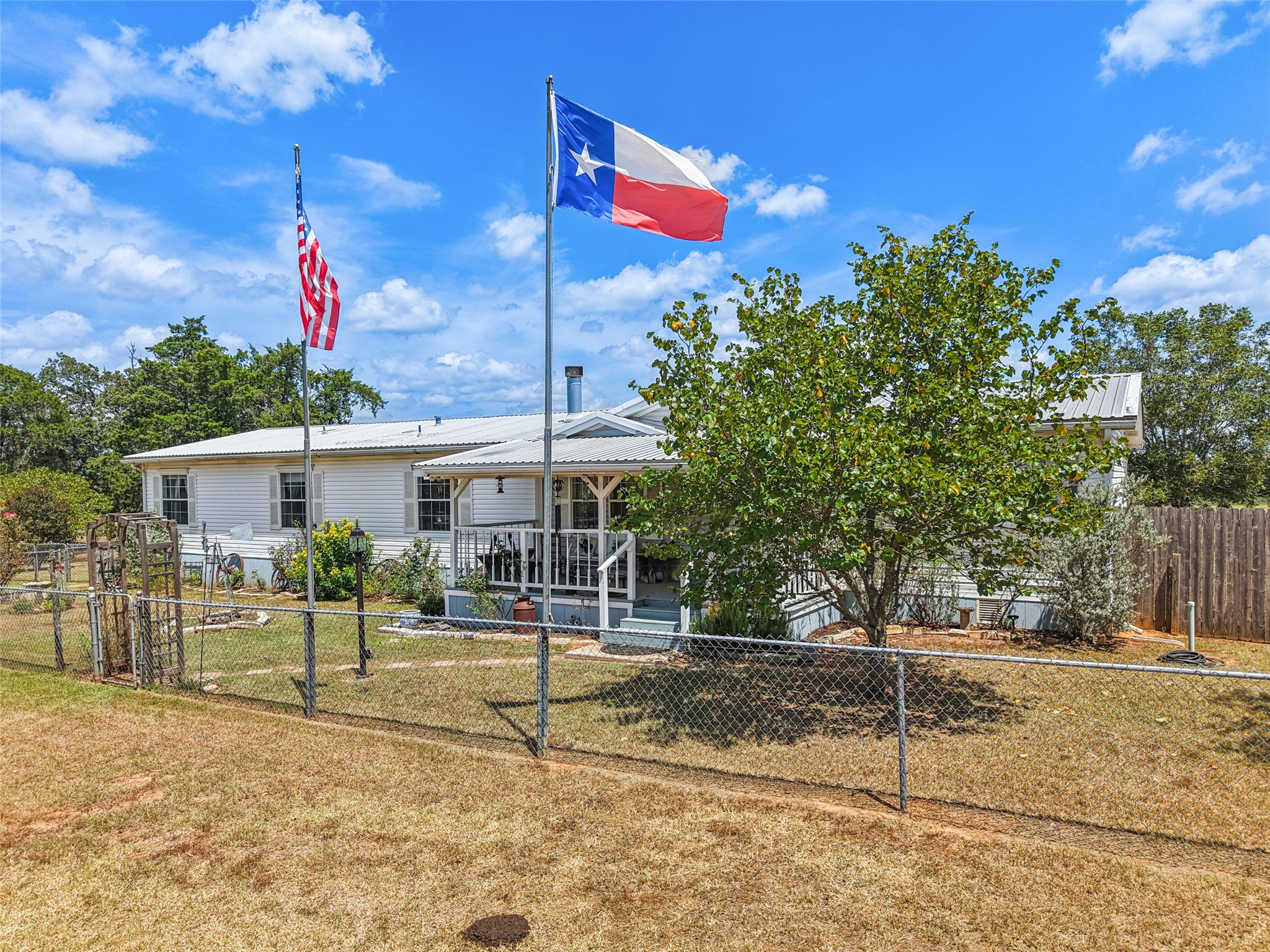 372 Hofferek Road Rosanky, TX 78953 - Photo 3 of 40 View of front of home with a metal roof and a fenced front yard