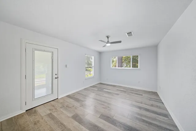 an empty room with windows and closet