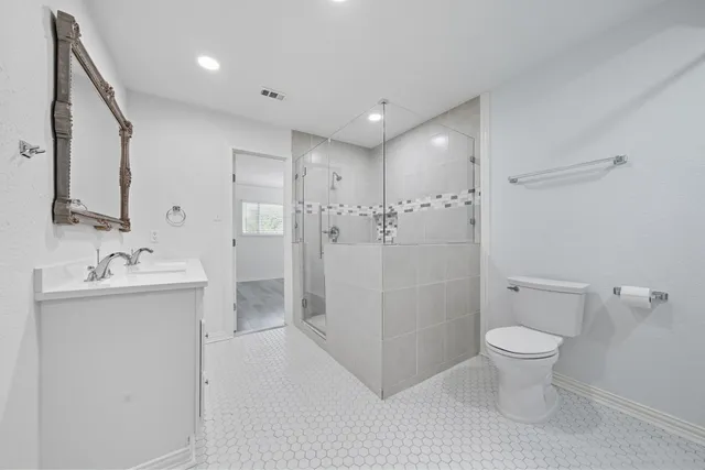 a bathroom with a sink toilet and shower